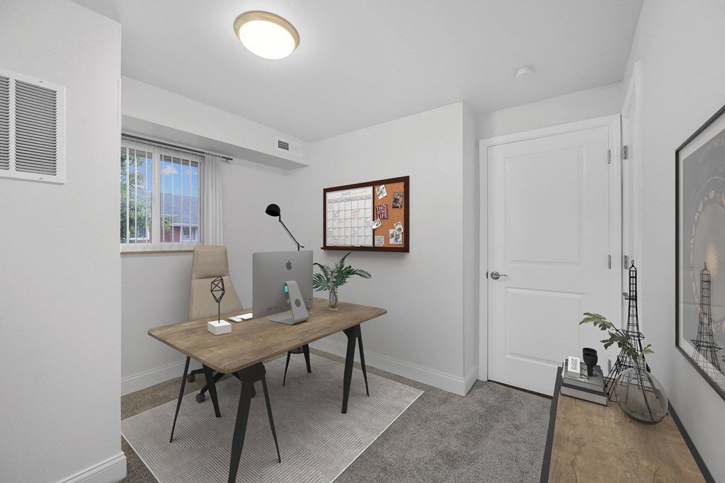 a room with a desk with a computer on it