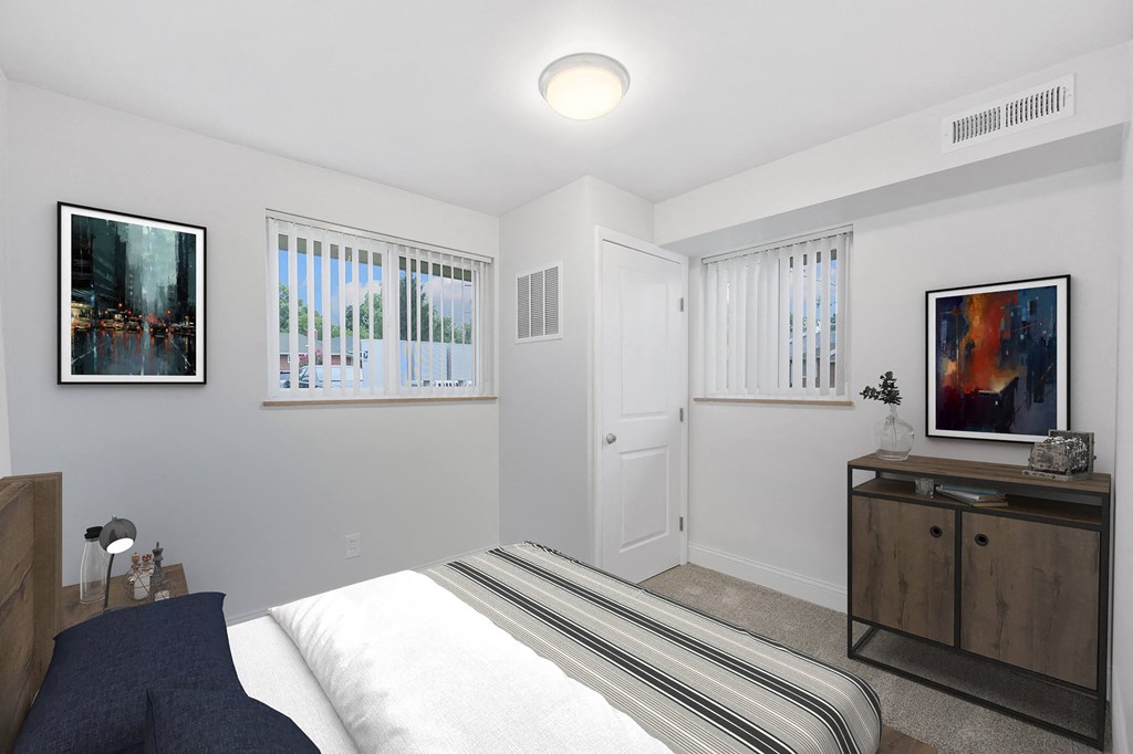 a white bedroom with a bed and two windows