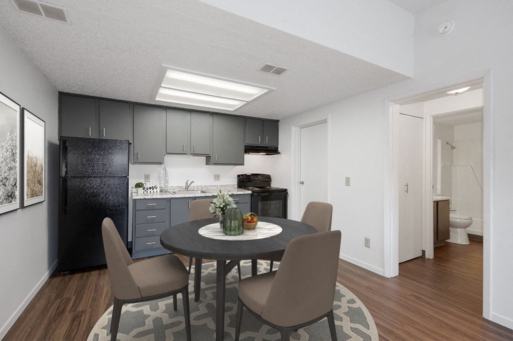 an open kitchen and dining room with a table and chairs