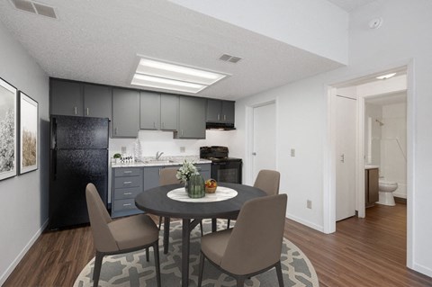 an open kitchen and dining room with a table and chairs
