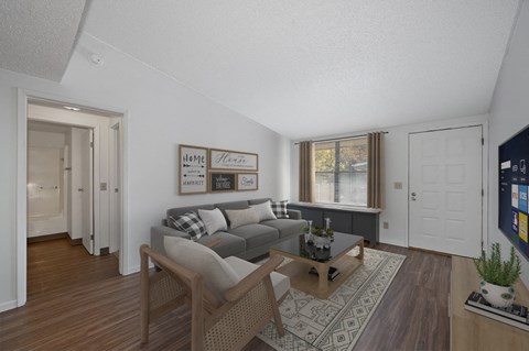 the living room of an apartment with a couch and a table