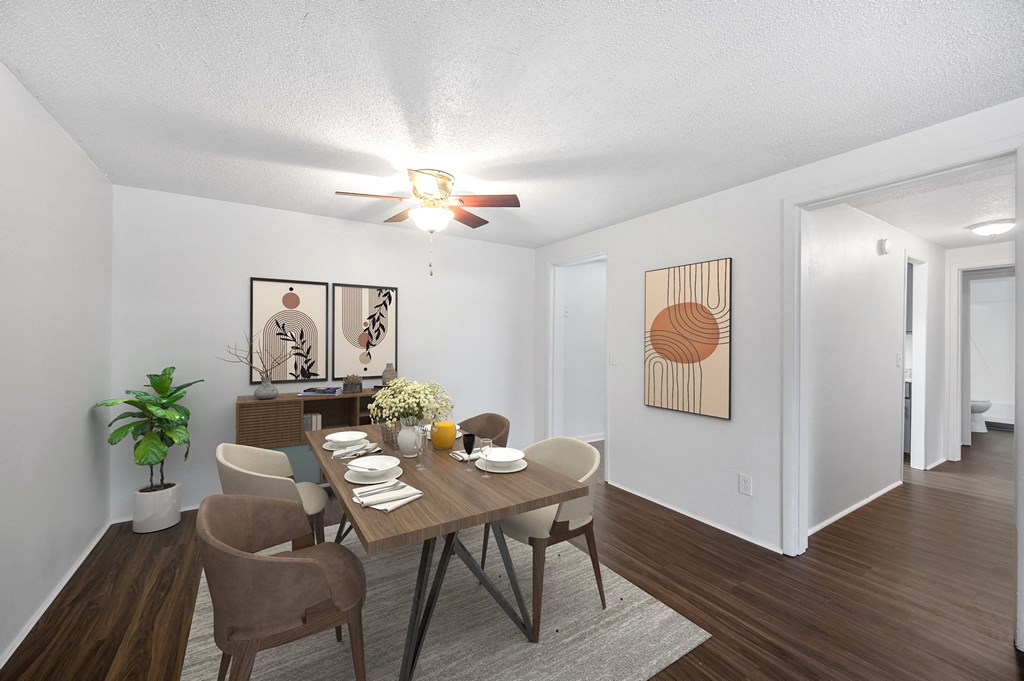 a dining room with a table and chairs and a ceiling fan