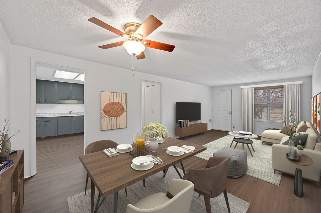 a living room and dining room with a table and a ceiling fan