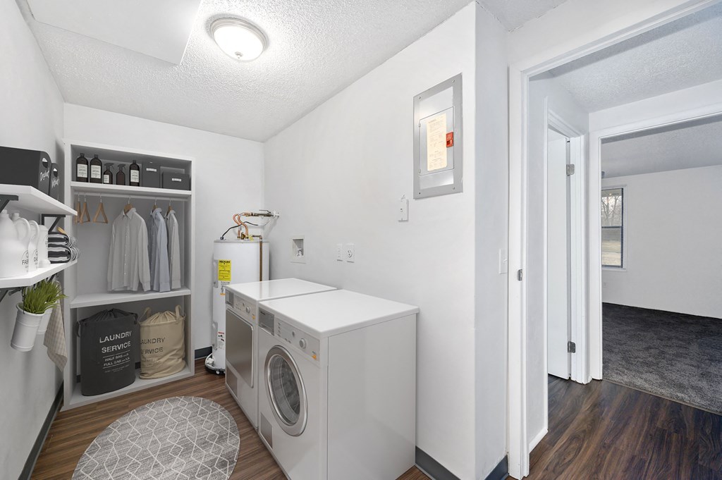 a small laundry room with a washing machine and a door to a closet