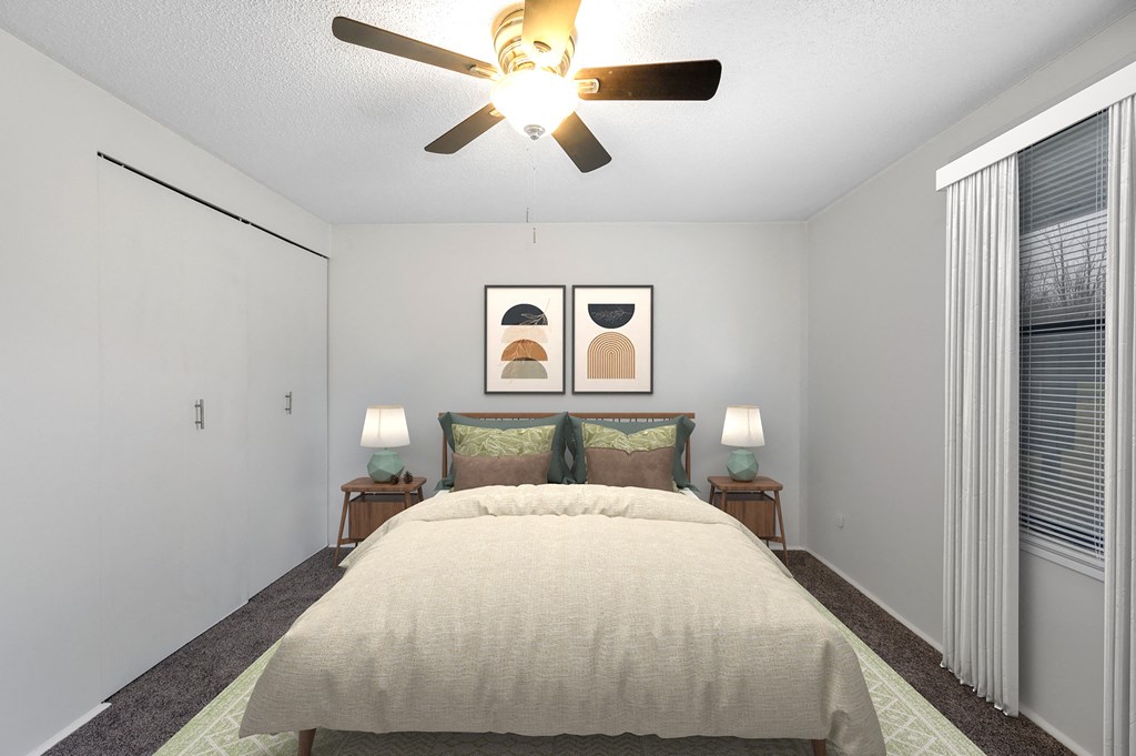 a bedroom with a large bed and a ceiling fan