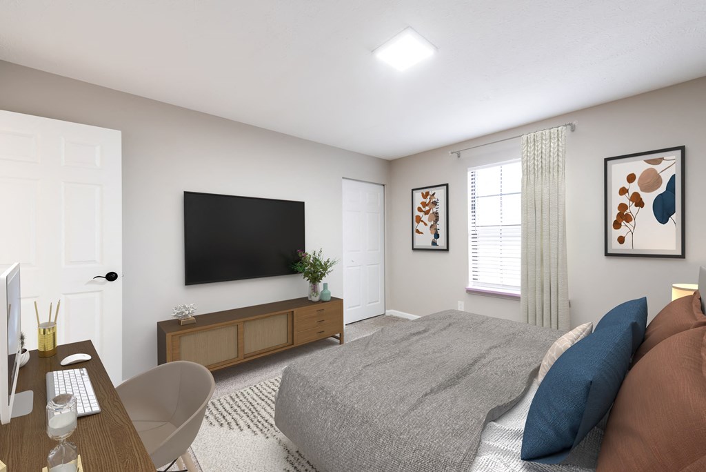 a bedroom with a large bed and a tv on the wall