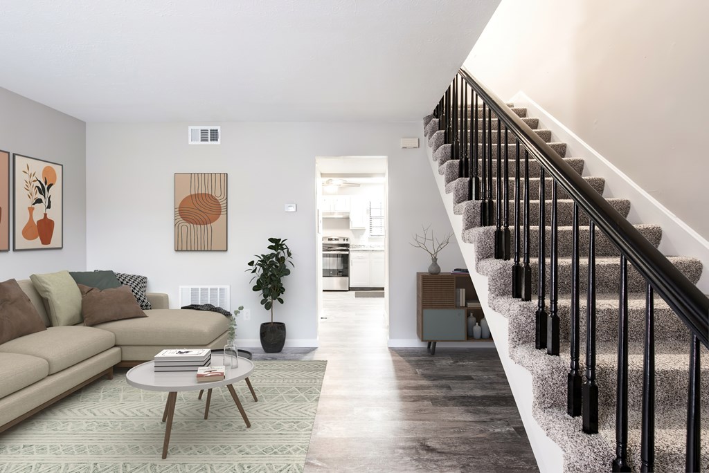 A living room with a staircase leading to the upper floor.