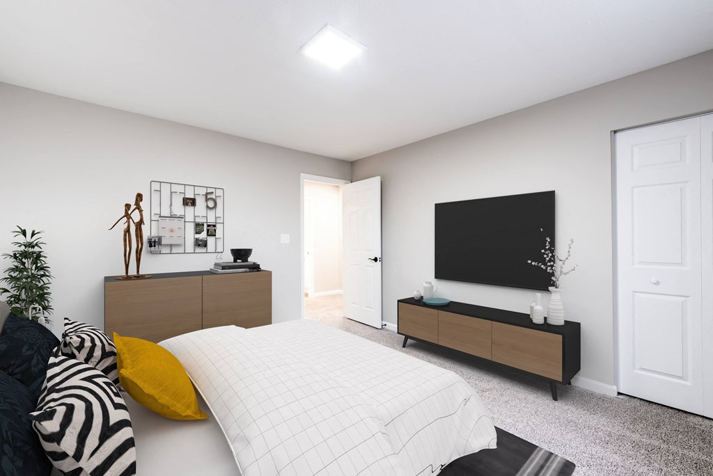 a bedroom with a large bed in front of a tv