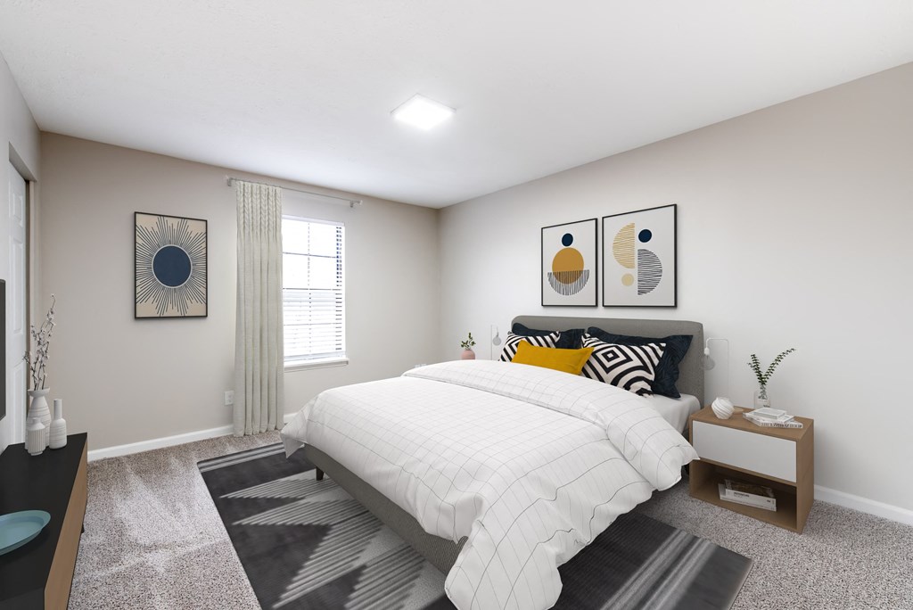 a bedroom with a large bed in front of a window with blinds