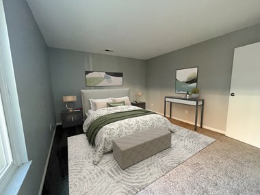 a bedroom with gray walls and a white and green bed - Photo Gallery 5