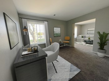 a living room filled with furniture and a large window - Photo Gallery 3