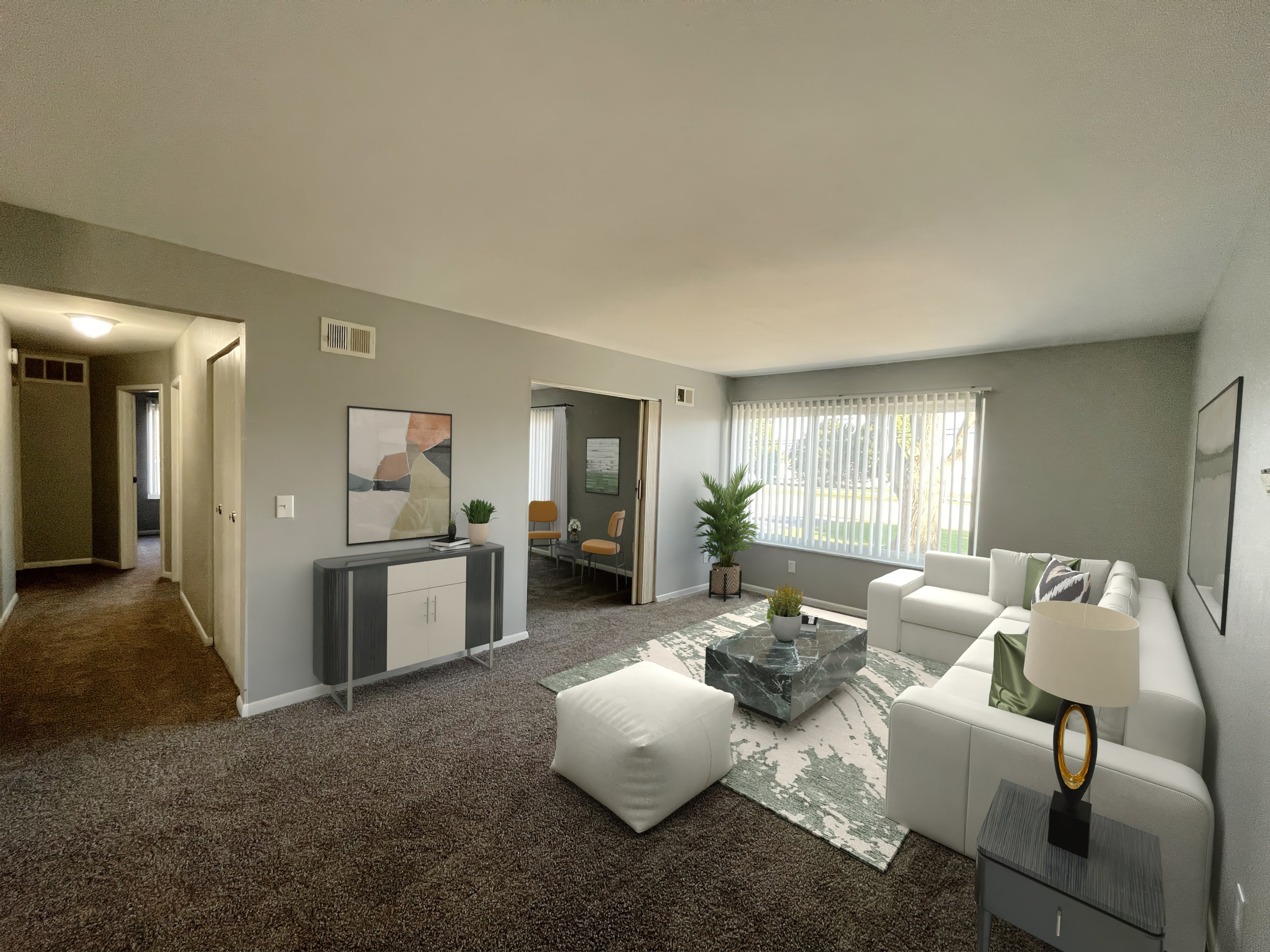 a living room with gray walls and brown carpet