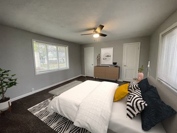a bedroom with gray walls and a white bed with zebra pillows - Photo Gallery 5