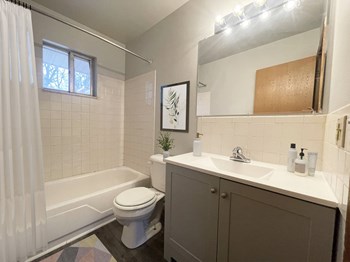 a bathroom with a white toilet next to a bathtub - Photo Gallery 4