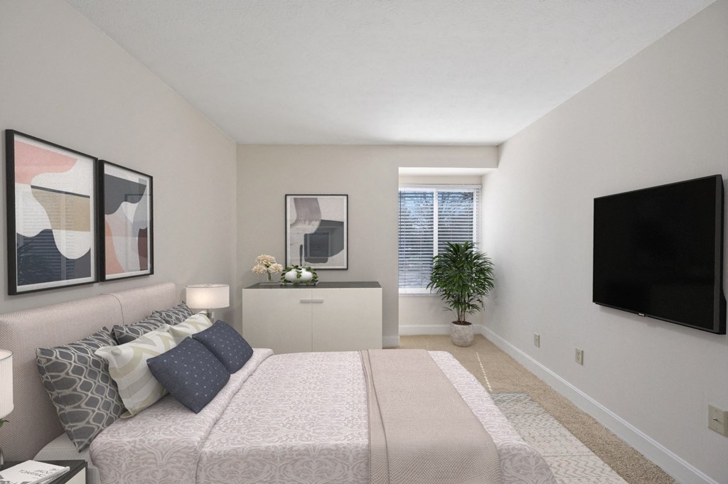 a bedroom with a large bed and a flat screen tv at Harpers Point Apartments, Ohio, 45249