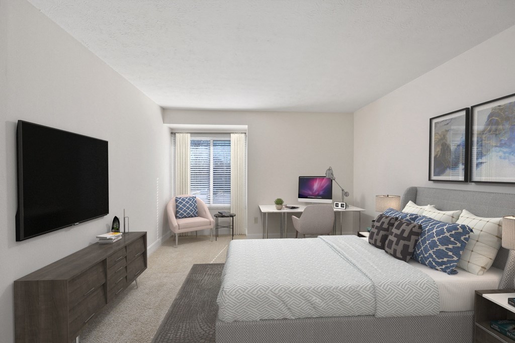 a bedroom with a large bed and a flat screen tv at Harpers Point Apartments, Cincinnati, Ohio