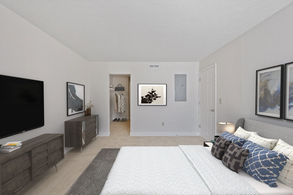 a bedroom with a large bed and a tv at Harpers Point Apartments, Cincinnati, OH, 45249