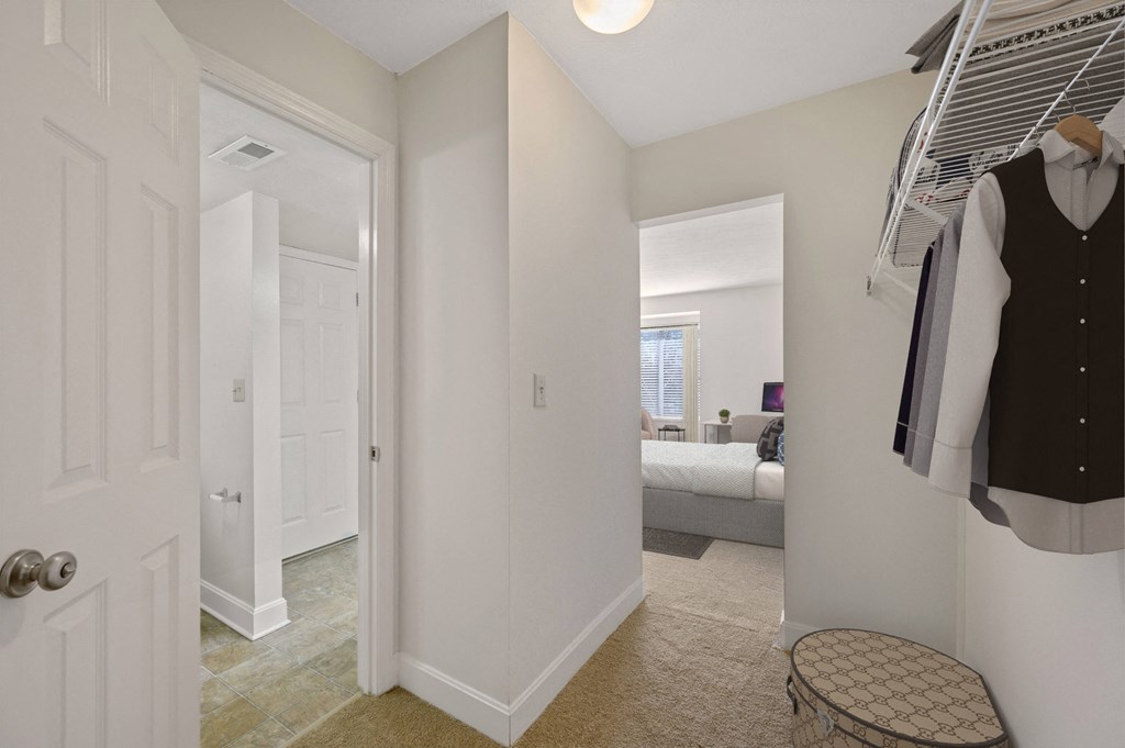 a bedroom with a bed and a closet at Harpers Point Apartments, Ohio