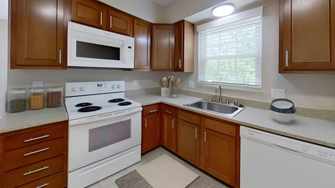 Kitchen with a white stove at Merrick Place, Lexington, 40502
