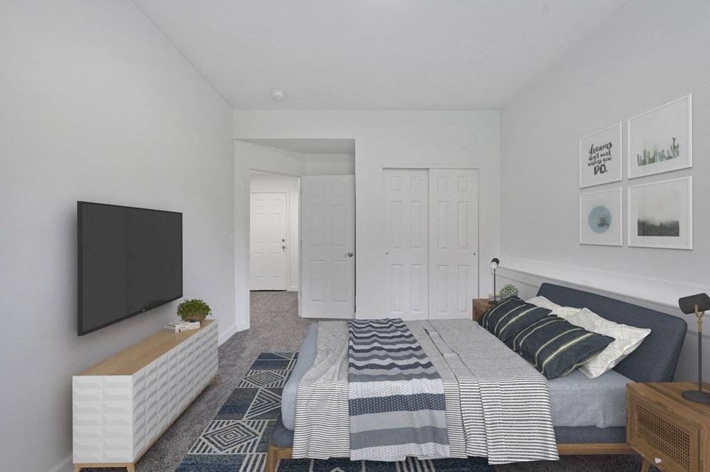 a bedroom with a bed and a tv in a 555 waverly unit