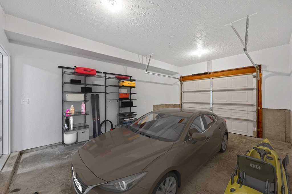 a car parked in a garage with a garage door open