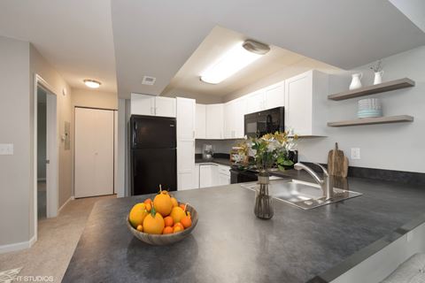 a kitchen with a bowl of fruit on the counter