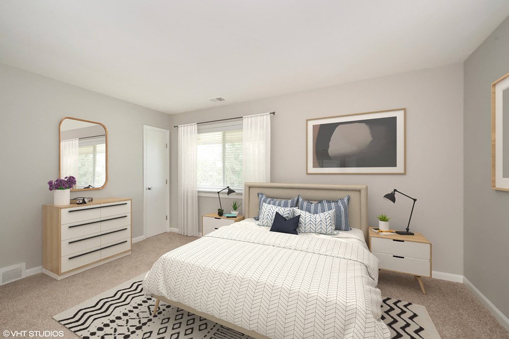 a bedroom with a large bed and a dresser with a mirror on it