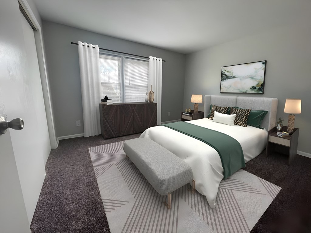 a bedroom with gray walls and a white bed with a green blanket