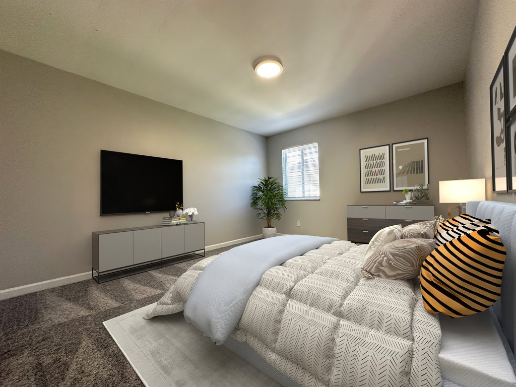 a master bedroom with a large bed and a tv