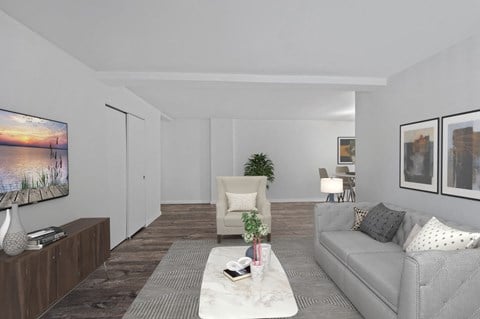a living room with a gray couch and a white coffee table