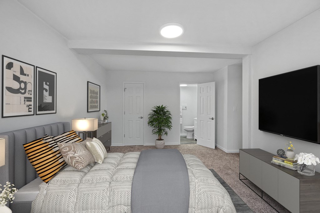 a bedroom with a large bed and a tv