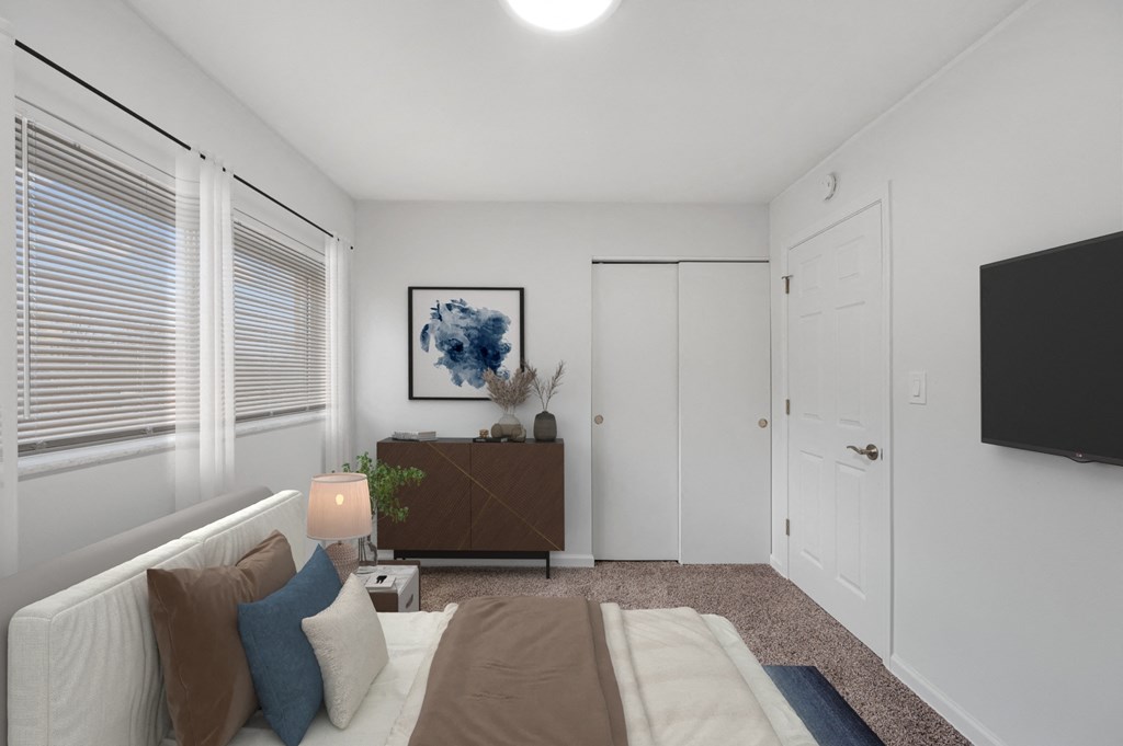 a bedroom with a bed and a dresser and a tv