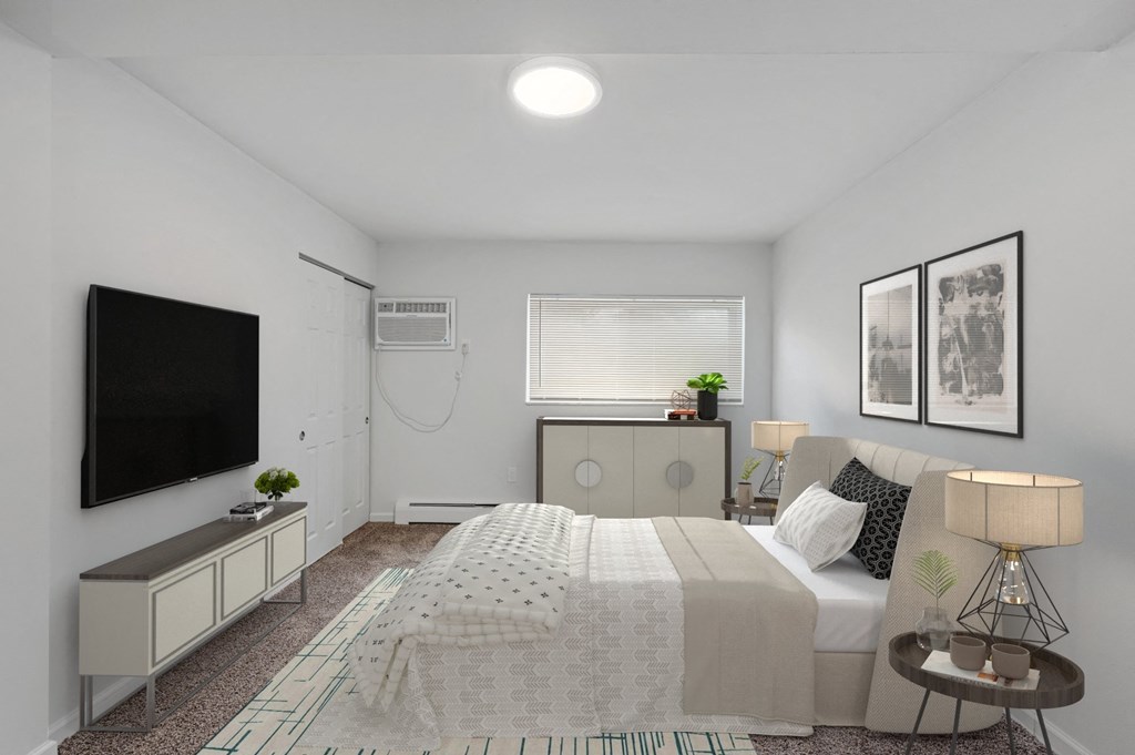 a bedroom with a large bed and a tv