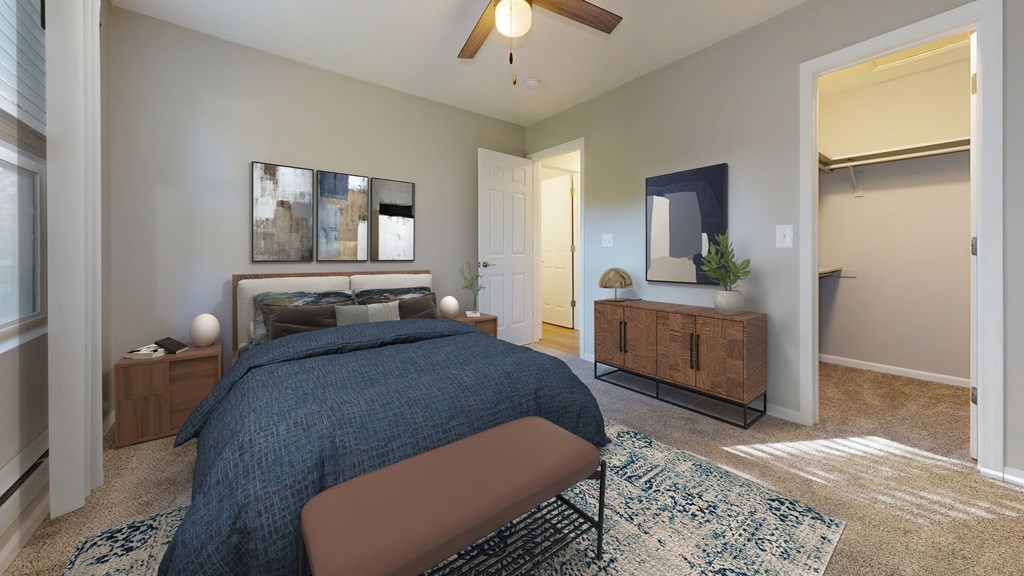 a bedroom with a large bed and a ceiling fan