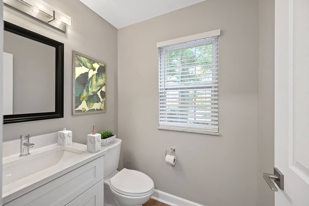 a bathroom with a toilet and a sink and a window at Indian Creek Apartments*, Ohio, 45236