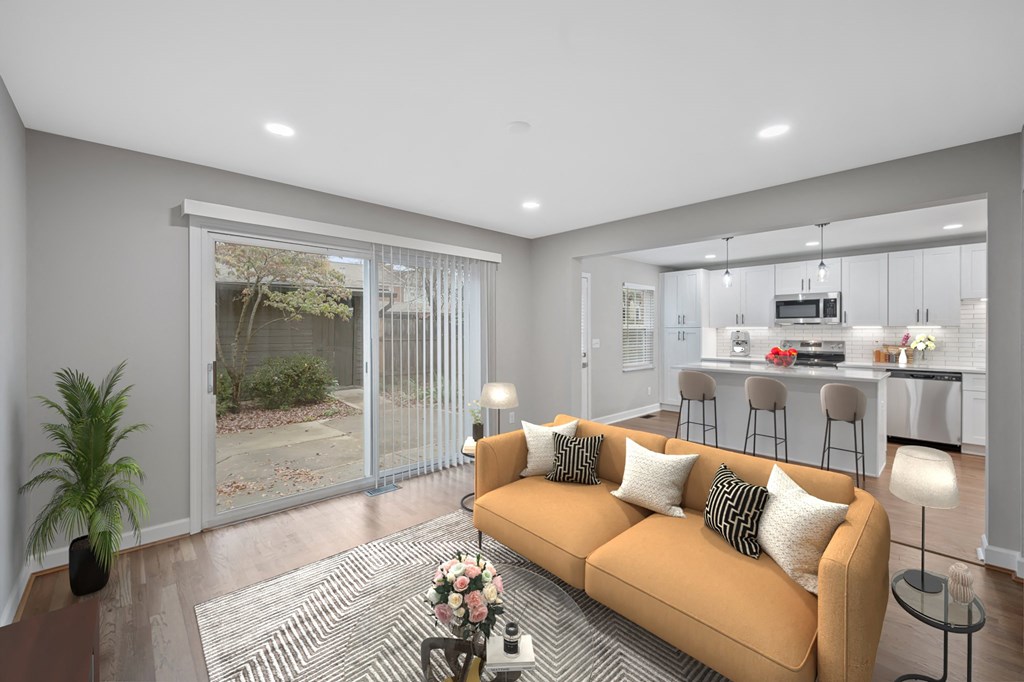 a living room with a couch and a kitchen in the background at Indian Creek Apartments*, Ohio