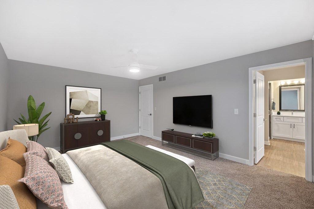 a bedroom with a large bed and a tv at Indian Creek Apartments*, Cincinnati, OH