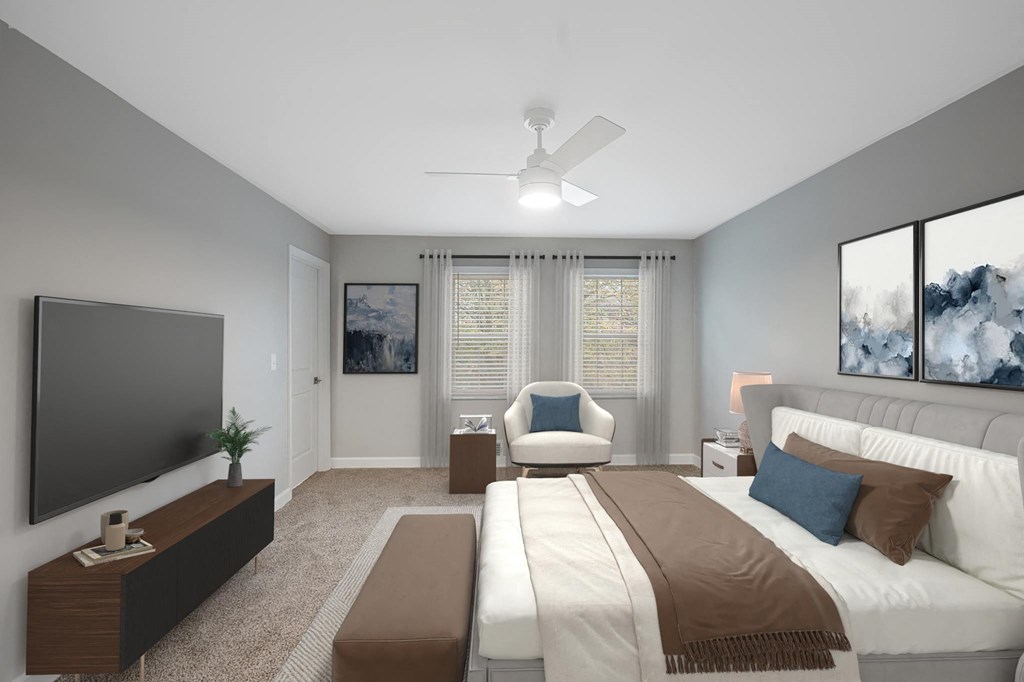 a master bedroom with a large bed and a ceiling fan at Indian Creek Apartments*, Cincinnati, OH