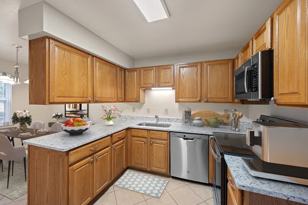 a large kitchen with wooden cabinets and stainless steel appliances at Indian Creek Apartments, Ohio, 45236