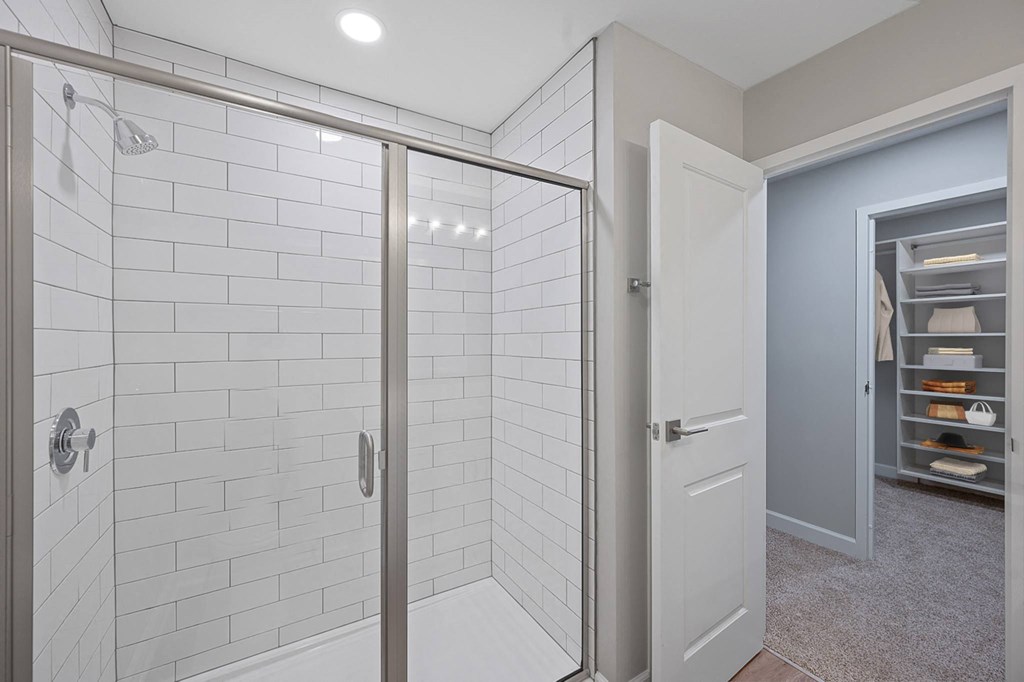 a white bathroom with a shower and a closet at Indian Creek Apartments*, Ohio, 45236