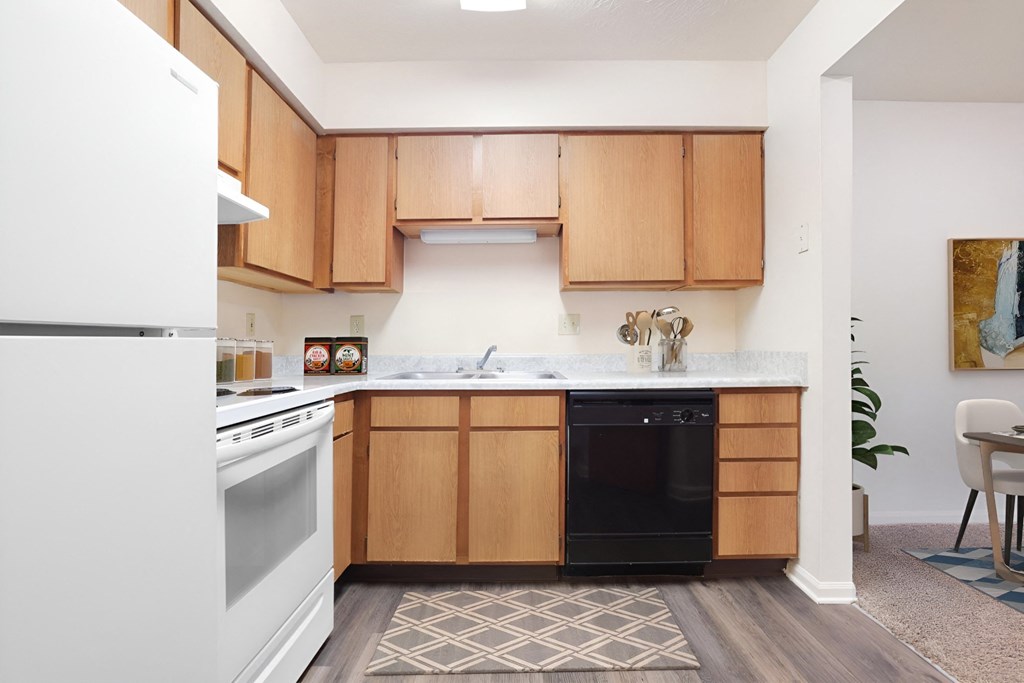 A kitchen with wooden cabinets and a white refrigerator.
