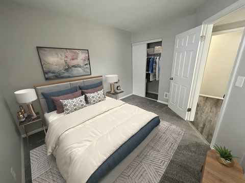 A bedroom with a large bed and a painting on the wall.
