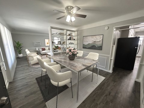 A dining room with a table and chairs.