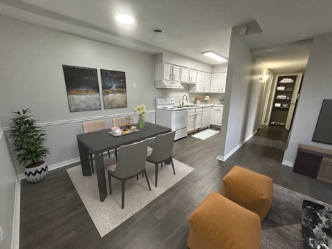 A modern dining room with a table set for two and a kitchen in the background.