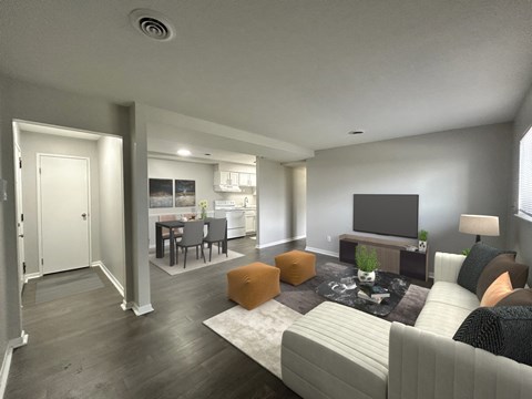 A modern living room with a grey couch, a fireplace, and a television.