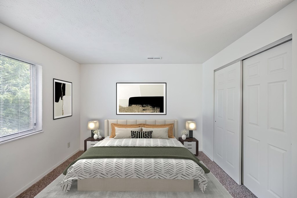 A bedroom with a large bed and a painting on the wall.