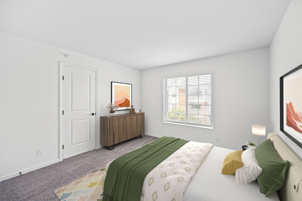 A bedroom with a bed, a dresser, and a window.