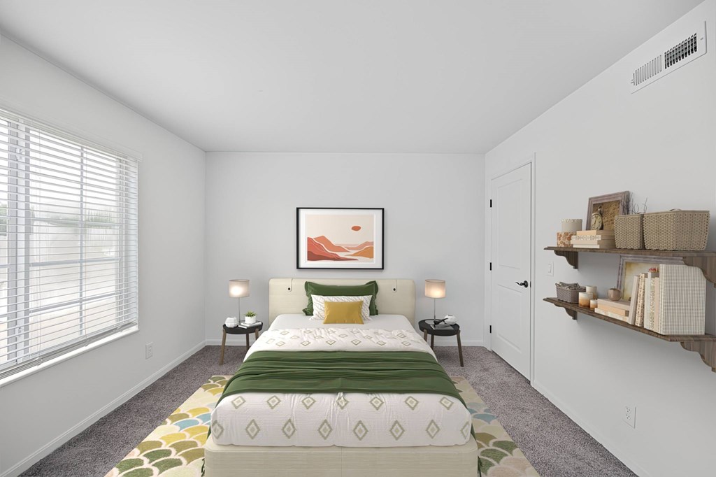 A bedroom with a large bed and a painting on the wall.