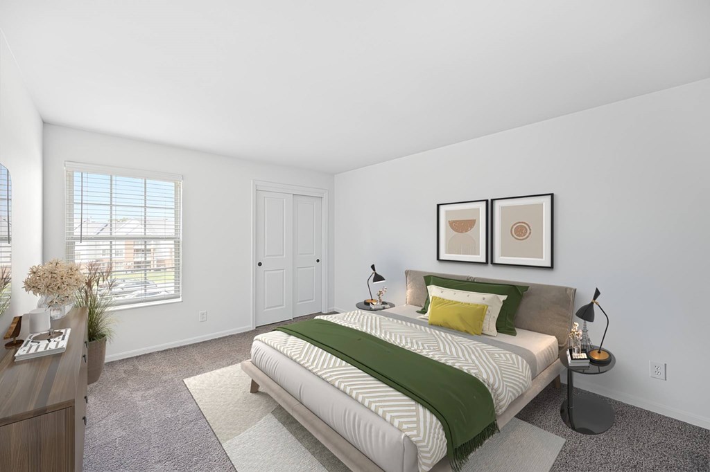 A bedroom with a bed, nightstand, and two framed pictures on the wall.