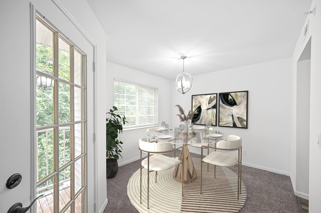 A white room with a round table and chairs.